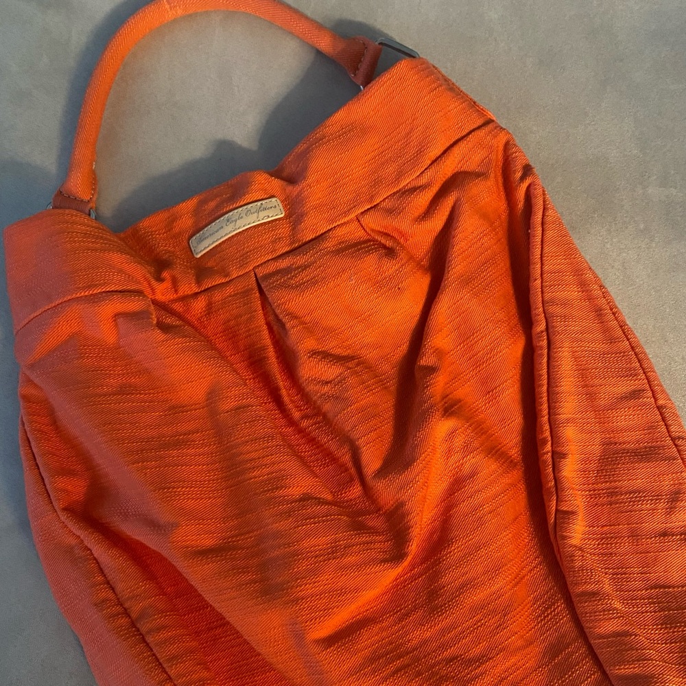 Pale orange summer bag. Inside pockets. Great for the beach or traveling.